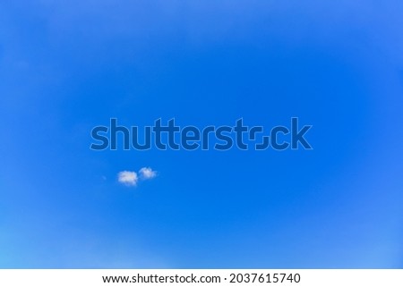 Small, fluffy and lonely clouds in the blue sky. for Copy space texture
