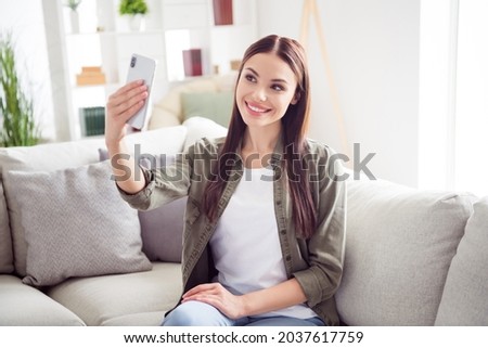 Photo of beautiful cute young woman dressed khaki shirt tacking selfie modern gadget indoors home room