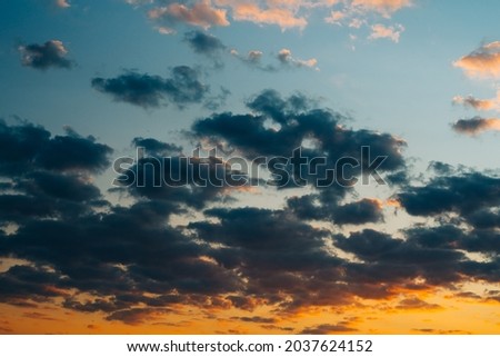 Dramatic sunset sky background with dark clouds, copy space
