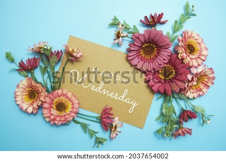 Happy Wednesday card typography text with flower bouquet on blue background
