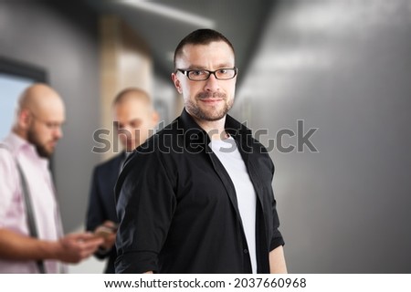 Portrait of happy male business owner in modern office.
