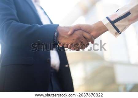 businessman shaking hands on a business cooperation agreement. Successful business woman handshaking after good deal