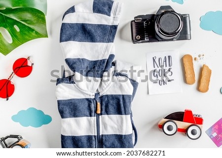 tourist outfit, clothes and camera for trip with kids white background top view