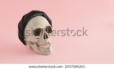 Creative beauty Halloween arrangement made of skull and hairband on a pink background. Halloween party concept.