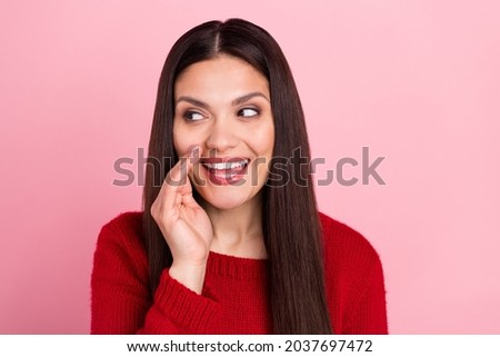 Photo of cunning dreamy funny girl palm mouth talk look empty space wear red pullover isolated pink color background