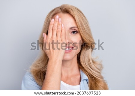 Portrait of young smiling good mood female cover close half face eyesight vision isolated on grey color background Royalty-Free Stock Photo #2037697523