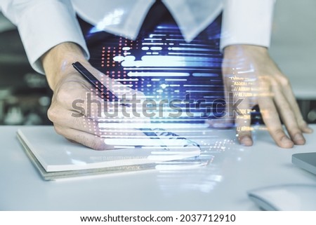 Abstract creative coding concept with world map and hand writing in notebook on background with laptop. Multiexposure