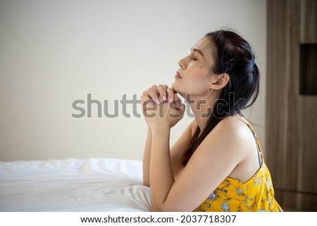 Asian woman with hand praying, Hands folded in prayer on the bed. Concept for faith, spirituality and religion.