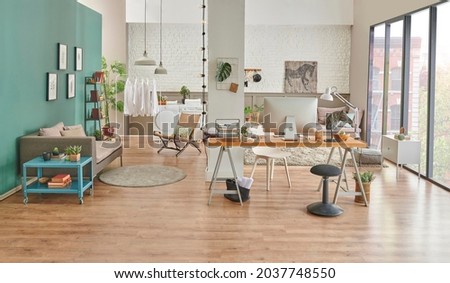 Working table and decorative living room style, modern home concept with laptop notebook poster and armchair decor.