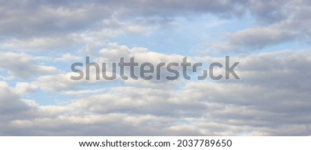 Big gray-white majestic clouds on soft blue sky Royalty-Free Stock Photo #2037789650