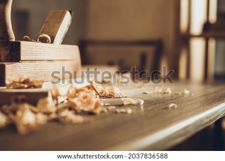 Plane jointer carpenter or joiner tool and wood shavings. Woodworking tools on wooden table. Carpentry workshop Royalty-Free Stock Photo #2037836588