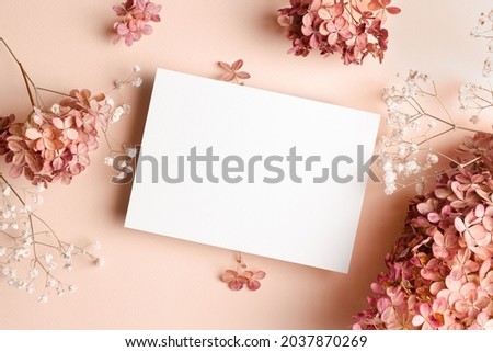 Invitation card mockup with hydrangea and gypsophila flowers decorations. Blank greeting card mockup. Royalty-Free Stock Photo #2037870269
