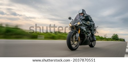 motorbike on the road driving fast. having fun on the empty highway on a motorcycle  journey. copyspace for your individual text. Royalty-Free Stock Photo #2037870551