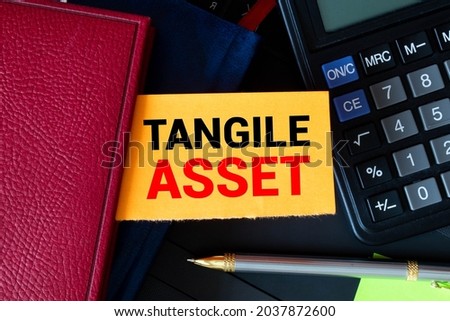 Tangible Asset text written on a notebook with pencils. Royalty-Free Stock Photo #2037872600