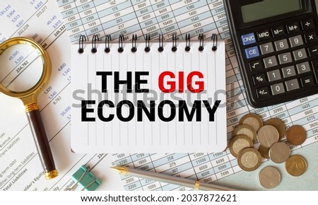 Handwriting text writing The Gig Economy. Concept meaning Market of Short-term contracts freelance work temporary white vertical paper written three words with black and red color.