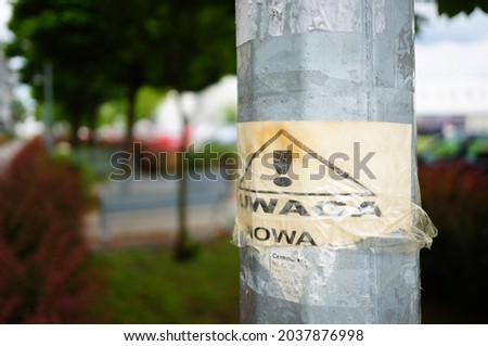 A shallow focus shot of a road warning sign on a metallic post in Poland