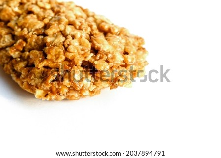 Cereal bar on white background. Healthy dessert snack. Cropped close-up view
