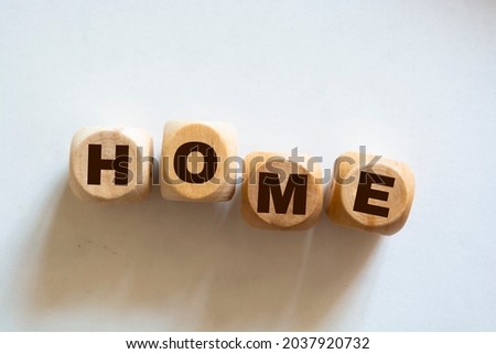 Wooden cubes with the word home, home on a white background. Real estate business or Emigration concept.