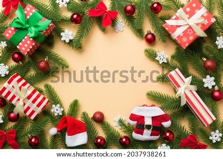 Christmas decorations and fir tree branch and gift boxon dark table. Top view frame with copy space.