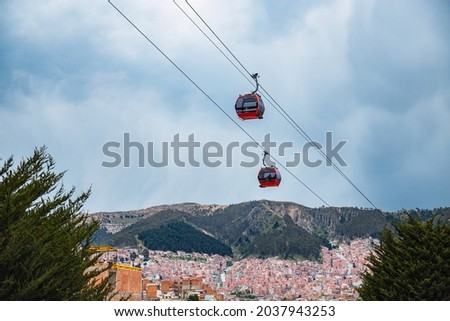 A view of two cable cars which are a part of the Teleferico system in La Paz Bolivia Royalty-Free Stock Photo #2037943253