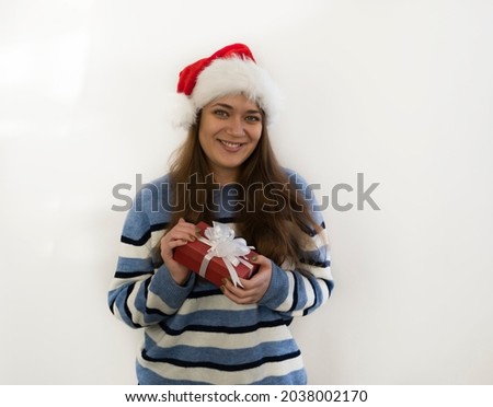 young woman in santa hat with christmas gift