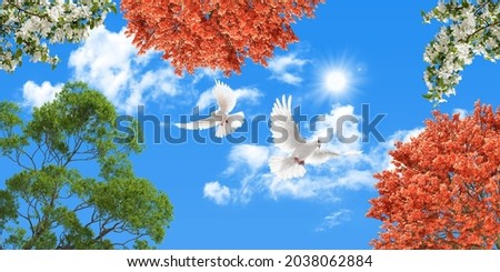 stretch ceiling picture. orange and green tree leaves, white flowers and birds flying in the sky. view of the sky from below. 