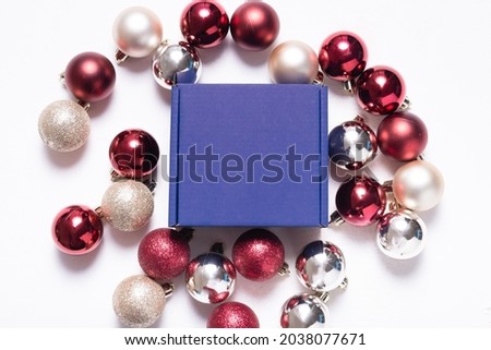 Brown cardboard mailer box decorated with Christmas ornaments