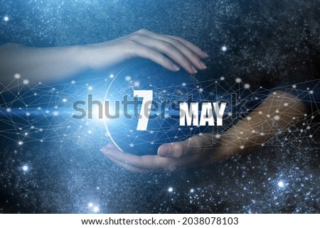 May 7th. Day 7 of month, Calendar date. Human holding in hands earth globe planet with calendar day. Elements of this image furnished by NASA. Spring month, day of the year concept