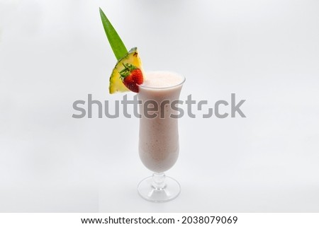 A refreshing cold glass of strawberry colada on a white background