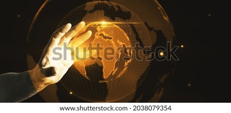 Hand holding glowing globe hologram on dark background. Digital interface and global innovation