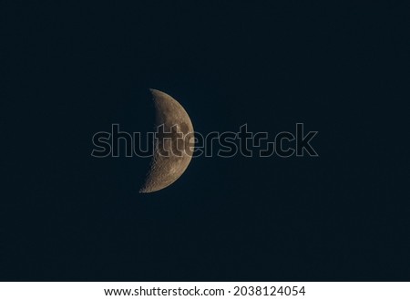 View of the moon in the night sky. Picture of the half moon related to astronomy