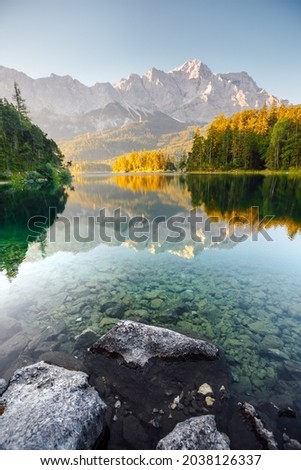 Breathtaking views of the famous Lake Eibsee in the sunlight. Location place resort Garmisch-Partenkirchen, Bavarian alp, sightseeing Europe. Perfect natural wallpaper. Discover the beauty of earth.