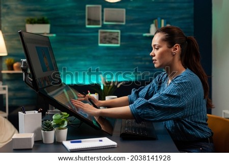 Photography designer working on image with stylus and touch interface to edit at studio agency. Woman with modern creativity equipment using monitor computer app professional technology