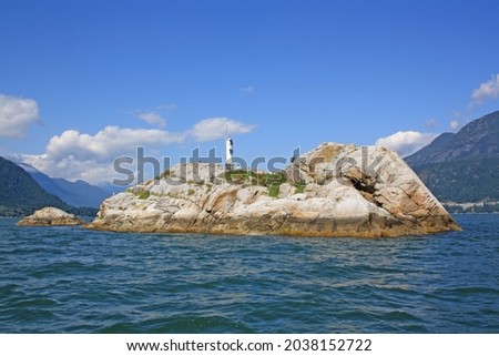 A shot of a rocky island in the middle of the sea in Vancouver, Canada