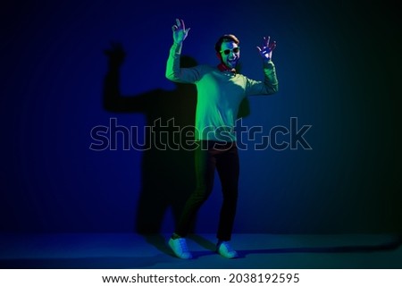 Full body photo of young man happy positive smile enjoy music nightclub dance hipster isolated over dark color background