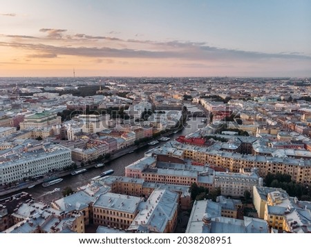 Sunset landscape of Fontanka river and old houses in St Petersburg. Boats float on the water. Russia in the summer. Place for tourism. Nevsky prospect on background. Cloudy sky. View from above.