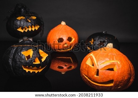 creepy orange and black pumpkins on dark background