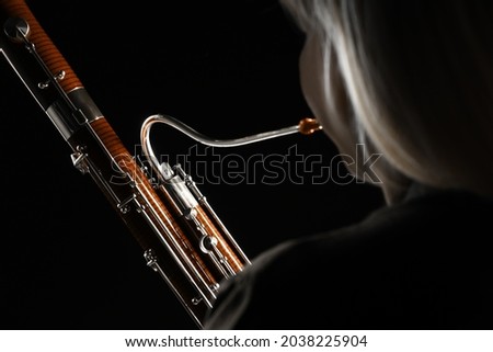 Bassoon orchestra player. Woodwind music instruments. Orchestral bass. Classical musical instrument close up Royalty-Free Stock Photo #2038225904