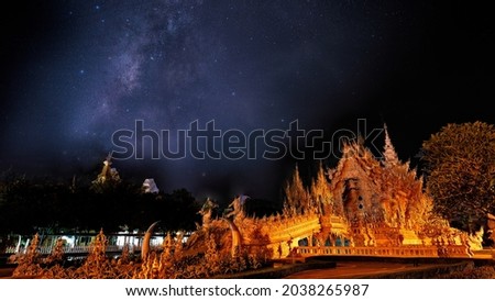 Beautiful scenery of the milky way on night sky at white temple, Chiangrai Thailand.Long exposure shooting and high iso used make this photo have noise.