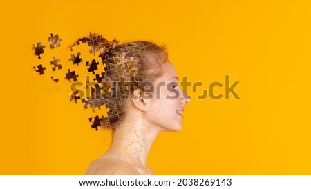 Dreaming. Conceptual image with head of young girl made of flying pieces of puzzle. Emotional, creative chaos in a person's head. Concept of mental health, equlity, diversity, happy lifestyle.