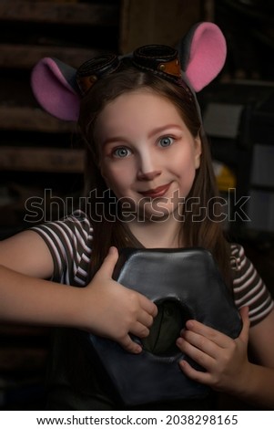 A fairy-tale fantasy, a girl in a mouse costume holds a large nut in her hands