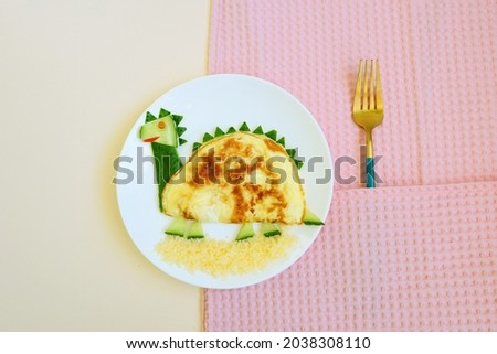 funny dish for Kids made of eggs, cucumbers and cheese. dinosaur picture. food art. creative idea for breakfast. snack time. 