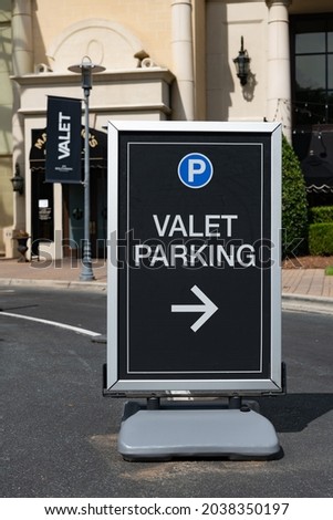 Valet parking sign at the entrance to a center with a shallow depth of field