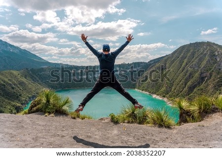 Happy man jumping over lagoon