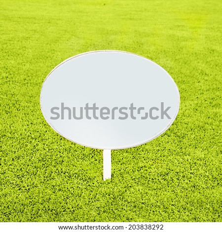 wooden white blank sign on grass