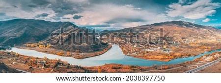 Mtskheta, Georgia. Top View Of Ancient Town Located At Valley Of Confluence Of Rivers Mtkvari Kura And Aragvi In Picturesque Highlands. Autumn Season. Panorama, Panoramic view Royalty-Free Stock Photo #2038397750