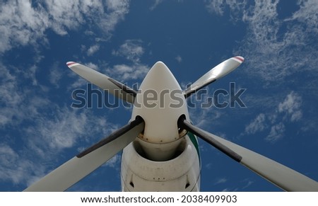 Low angle view propeller blade of turboprop engine with blue sky Royalty-Free Stock Photo #2038409903
