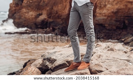 Gray men's elegant chinos pants, close-up, advertising banner. Royalty-Free Stock Photo #2038415168