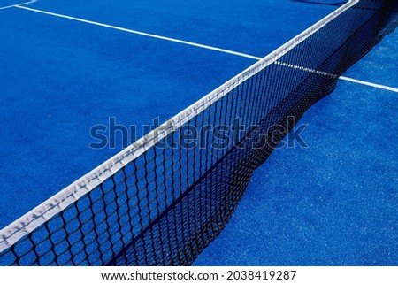 Net on a blue paddle tennis court Royalty-Free Stock Photo #2038419287