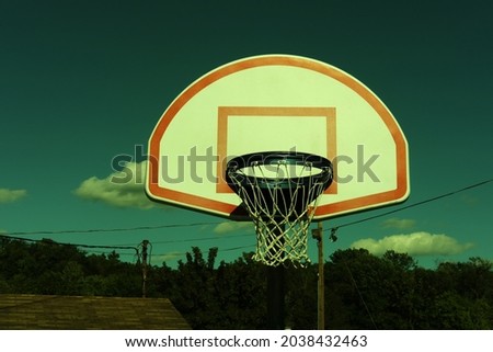 Vintage retro stylized urban basketball hoop against a blue sky